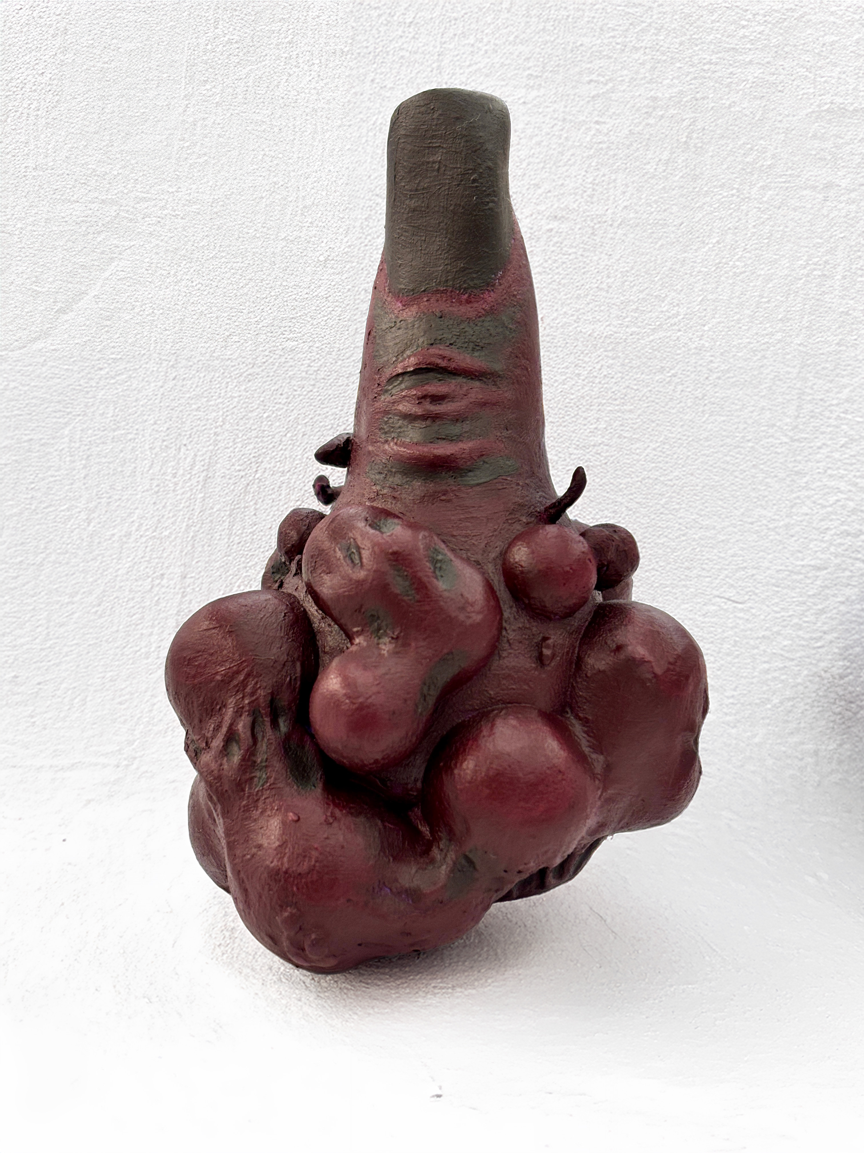 Texture detail of the Sukuna's finger sculpt: the painted skin surface, wound finishes, and color variation across the burgundy tones.